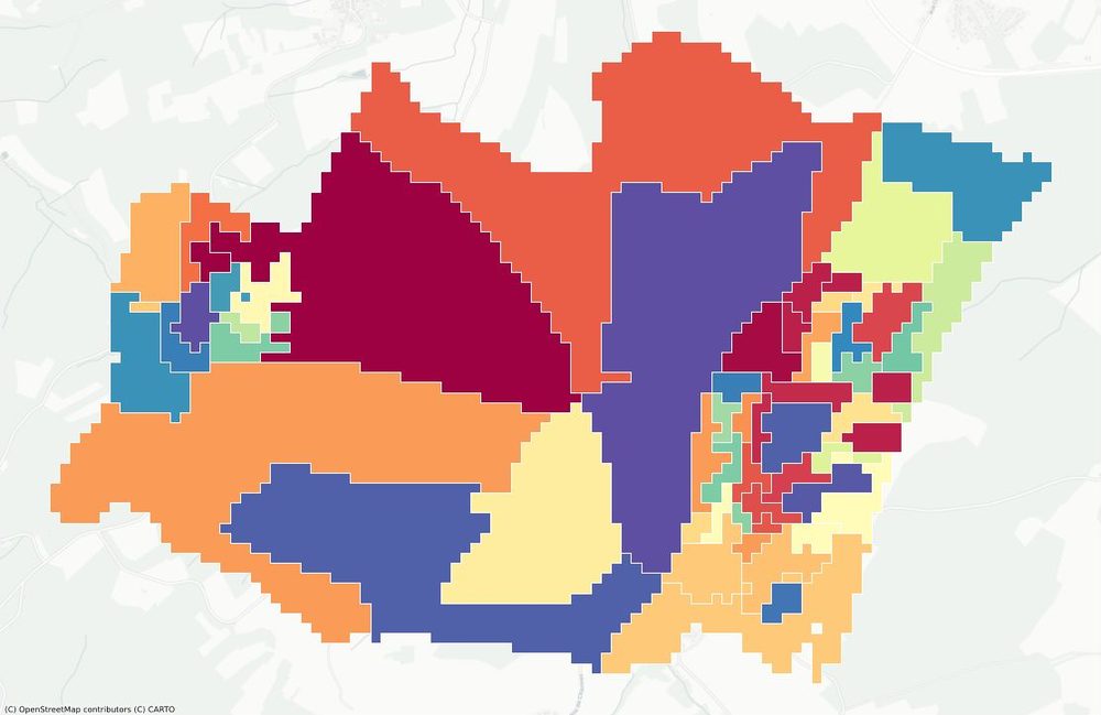Map of one Danish area divided into irregular, colorful regions that follow roads, each meeting minimum population and household thresholds.